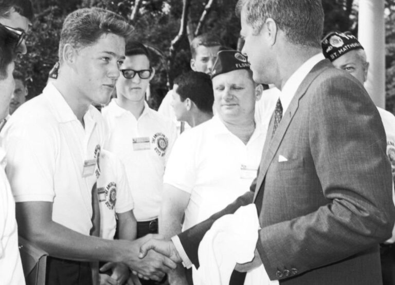Historic photo of teenager Bill Clinton shaking hands with President Kennedy