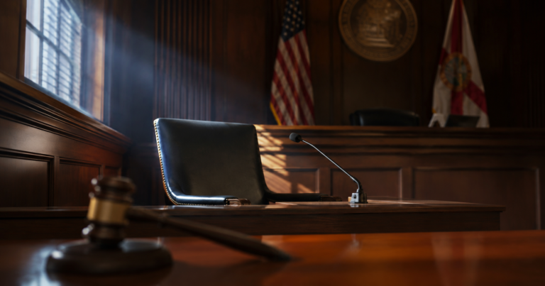 Empty witness chair in a Florida courtroom representing Judge Garagozlo's blocked deposition in the Wagner v. DeSantis Brevard judicial election case