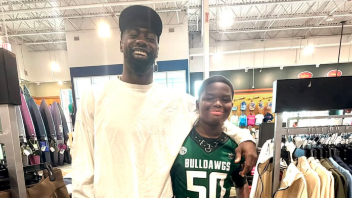NFL safety Marcus Maye poses with Melbourne Bulldawgs player Tiemayne Lawson inside a Melbourne, Florida sporting goods store