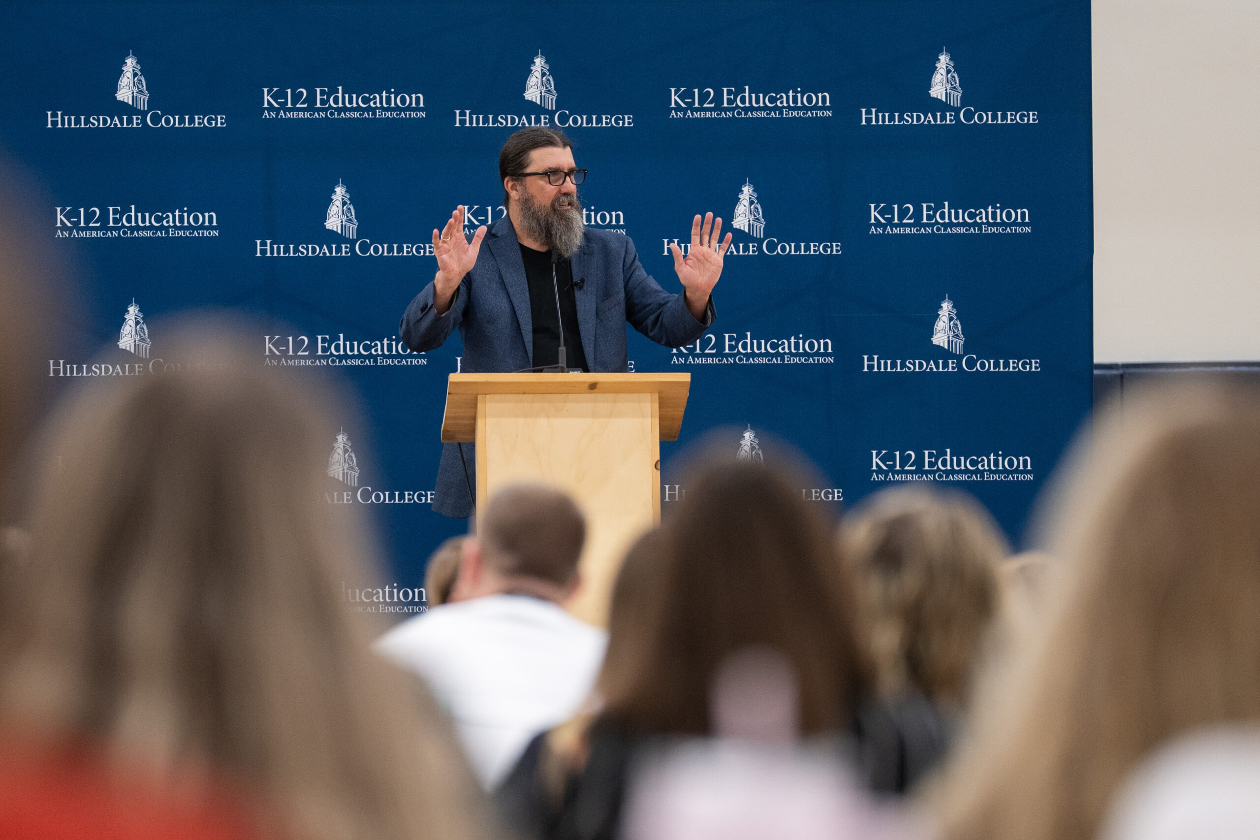 Justin Jackson speaks at a lectern during the Hillsdale teaching seminar at Pineapple Cove.